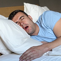Man snoring in bed