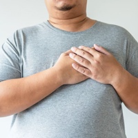 Large man holding his hands over his heart