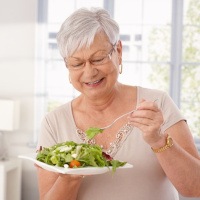 an older woman enjoying a salad