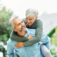 an older couple smiling and laughing together