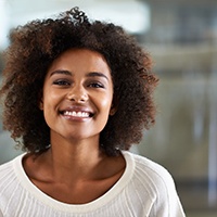 Woman in white sweater smiling