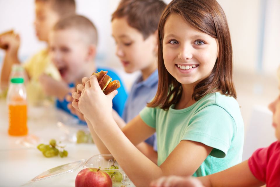 Children eating lunch in a school cafeteria.