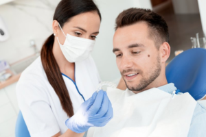 Dentist showing patient his Invisalign refinement tray